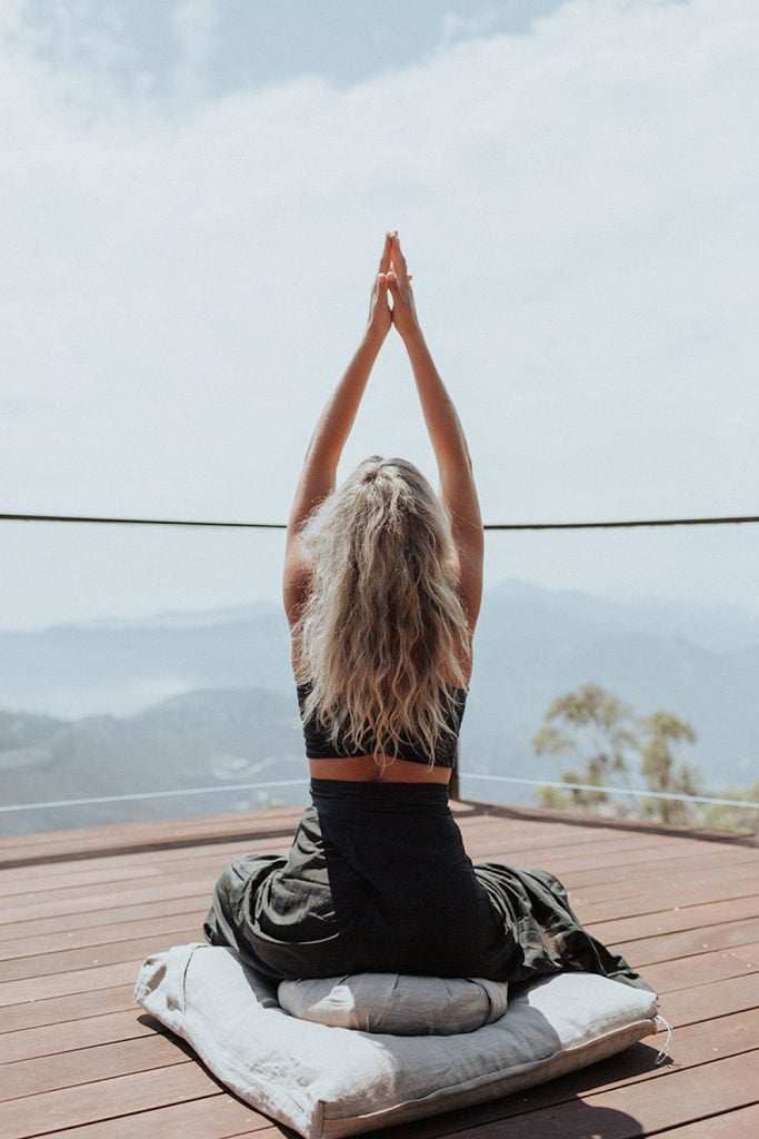 Blonde woman doing yoga outside.