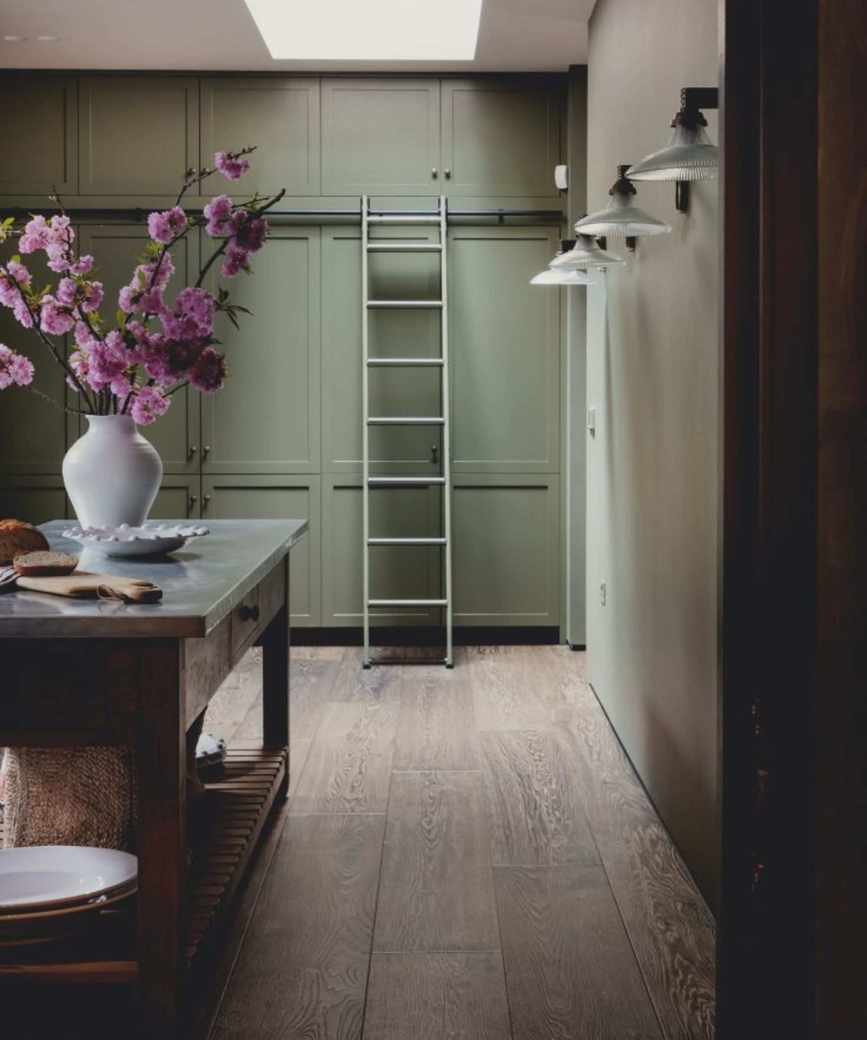 kitchen with wooden flooring and green cabinetry