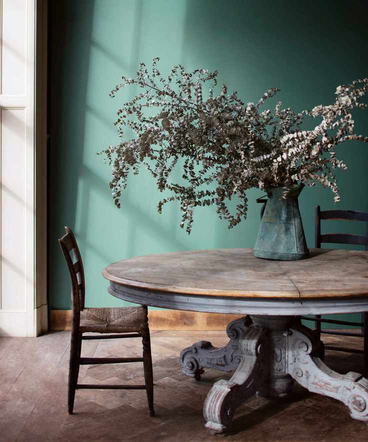 Dining room with green painted wall and wood table