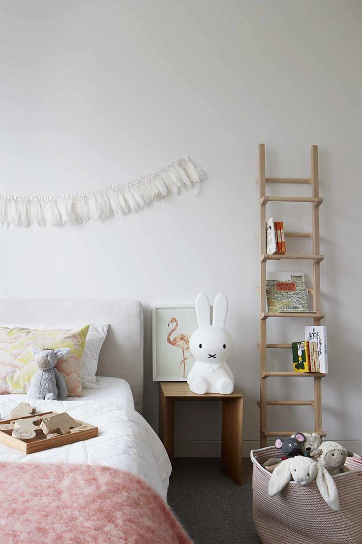 Girl's bedroom with white walls and ladder storage