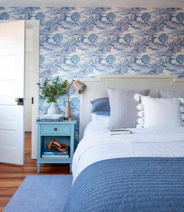 Charming blue bedroom adorned with toile wallpaper