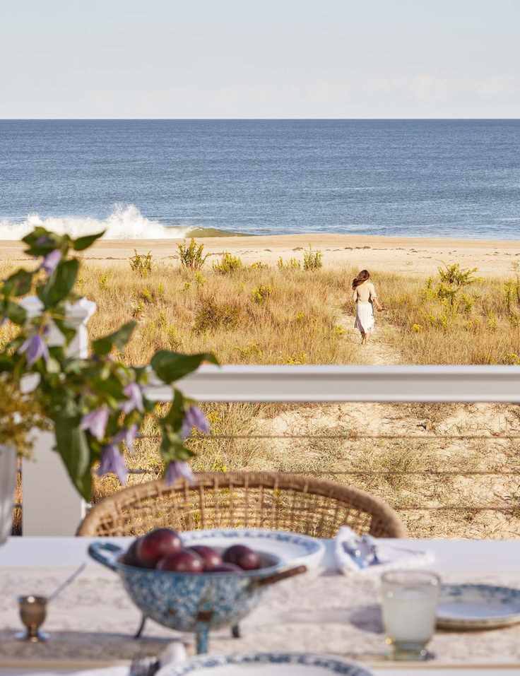 Outdoor dining setup overlooking a sandy beach