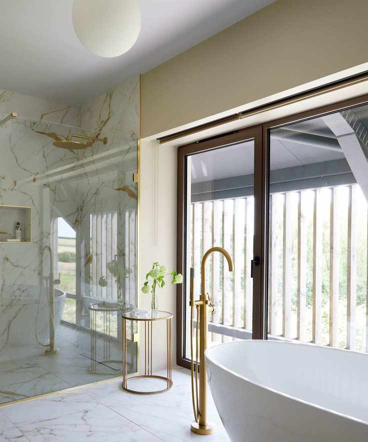Large bathroom with marble tiles and pendant lighting