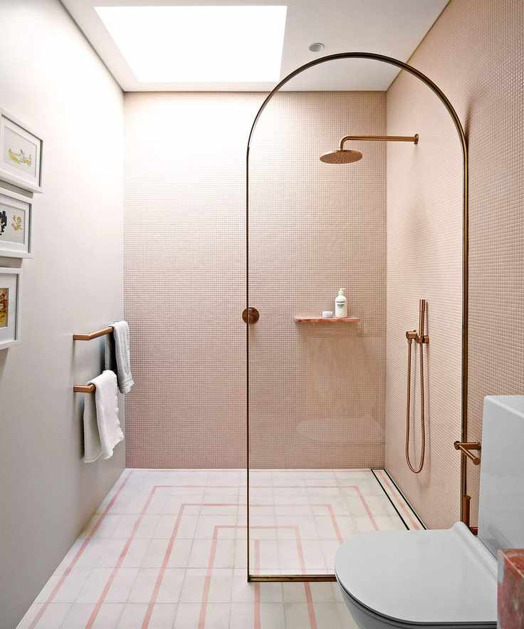 Shower room with pink tiles and curved screen