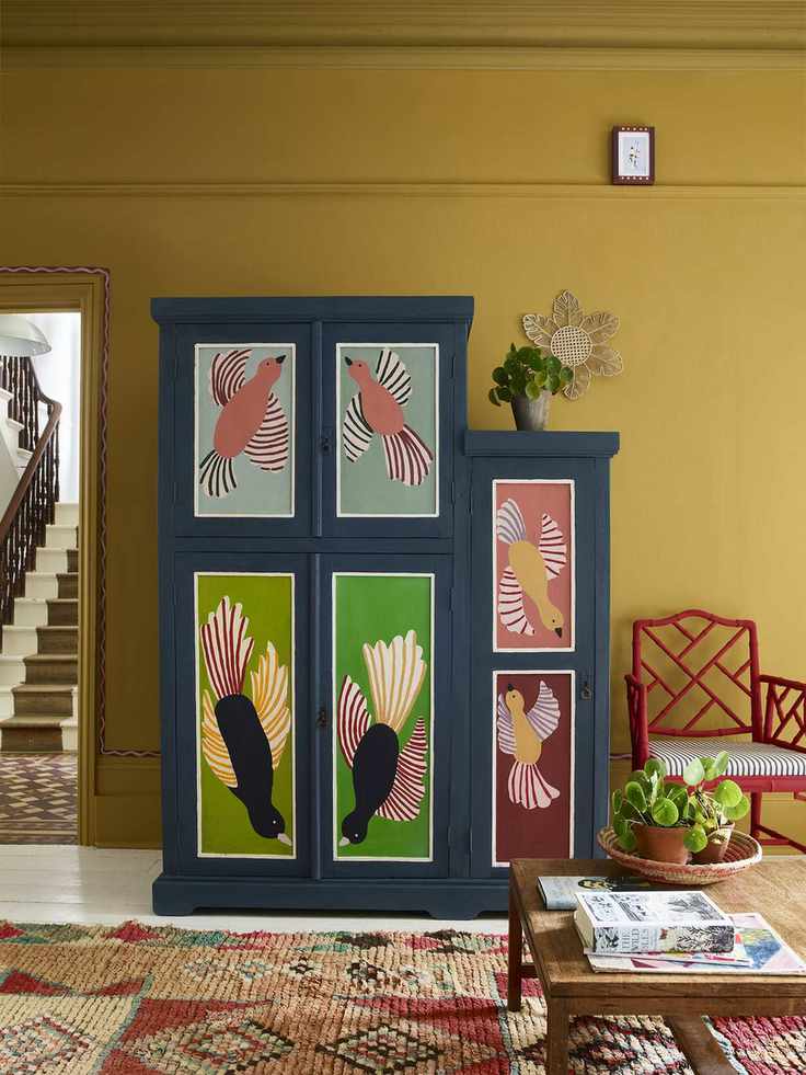 Yellow living room with a painted cabinet