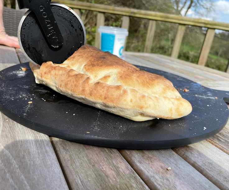 A calezone made in the Gozney Arc being cut in two