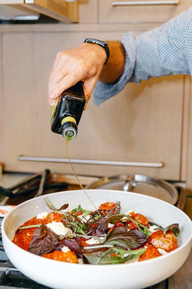 olive oil drizzle on savory lamb meatballs