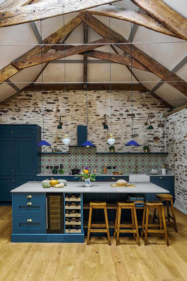 Kitchen in a barn conversion with ceiling pendant lights