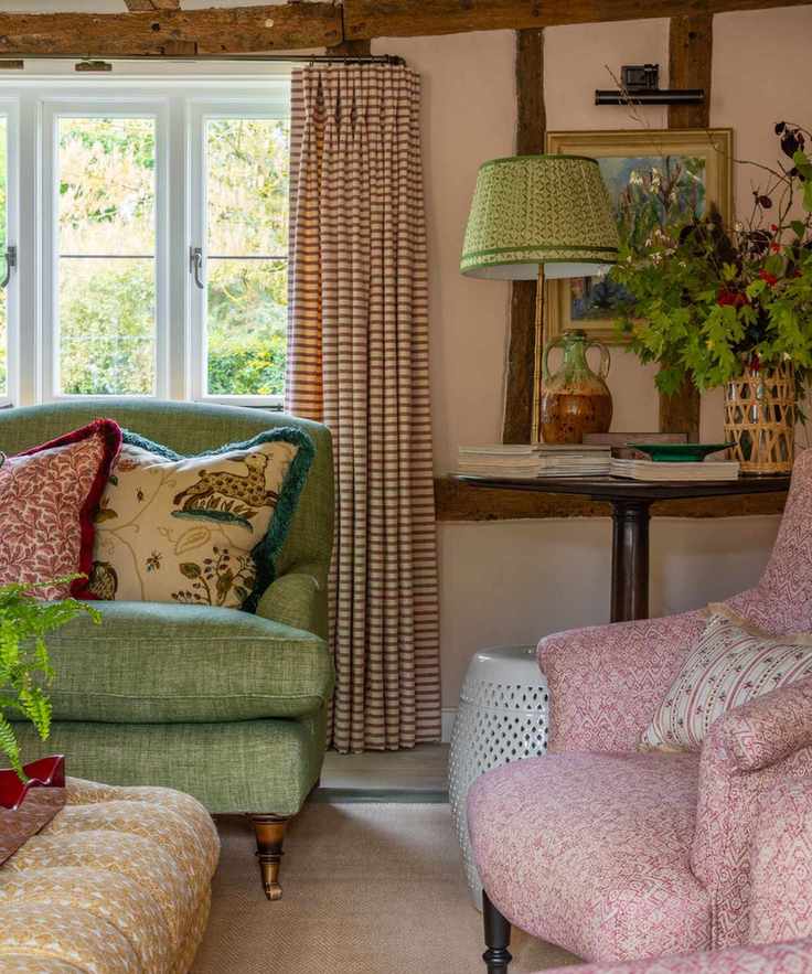cottage sitting room with decorated with a mix of fabrics including stripes, small prints and decorative prints