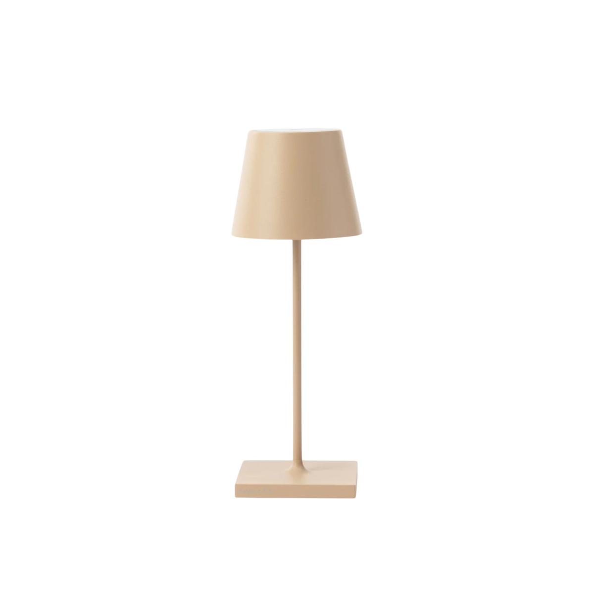 A sandy colored table lamp with a drum-shaped shade