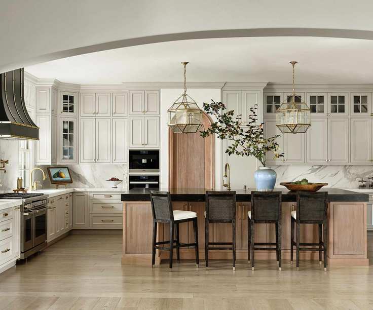 kitchen with cream units and black cooker hood with wood island detail