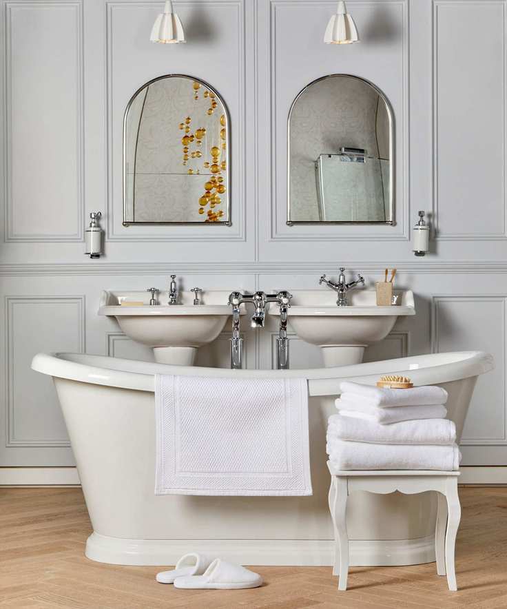 white towels in stool next to bath