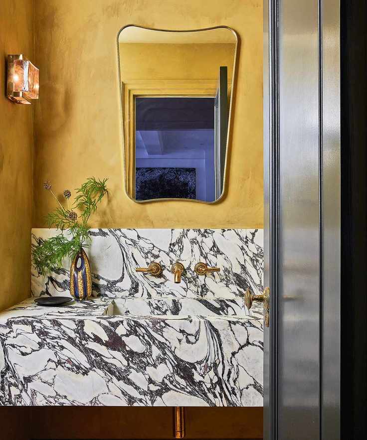 Chic powder room with golden walls