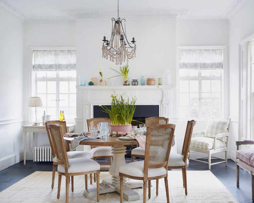 Bright, all-white dining room with natural light and elegant decor