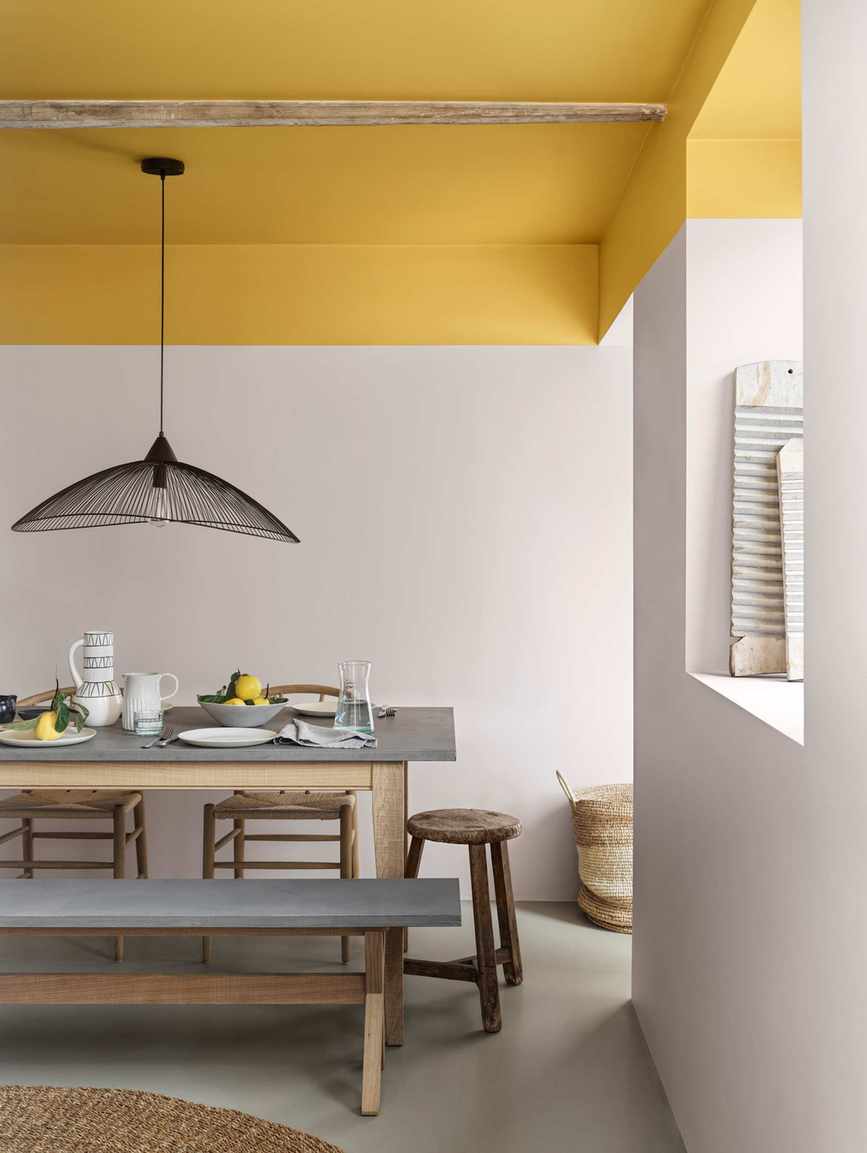 kitchen diner with yellow ceiling and white walls