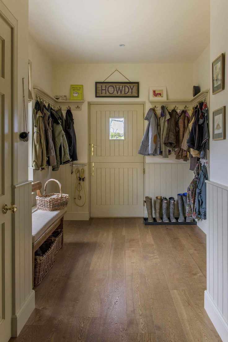 boot room with coat pegs and barn door