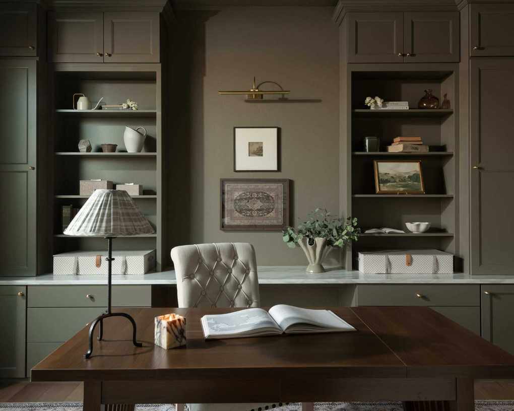 home office with gray-green color drenched walls and built-in shelving